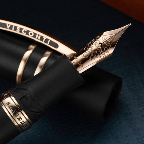 Visconti fountain pen nib in rose gold photographed against a dark background