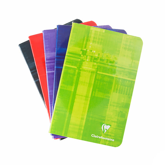 Set of colorful notebooks with a green one in front on a white background