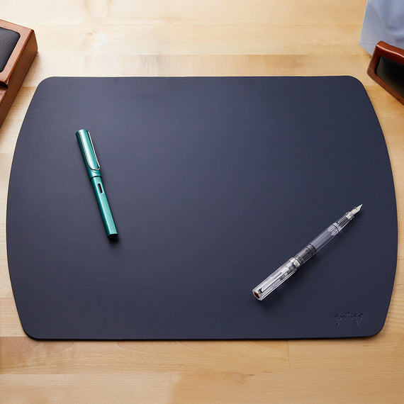 A sophisticated navy blue leather writing mat with an elegant texture and durable quality for an enhanced writing experience.
