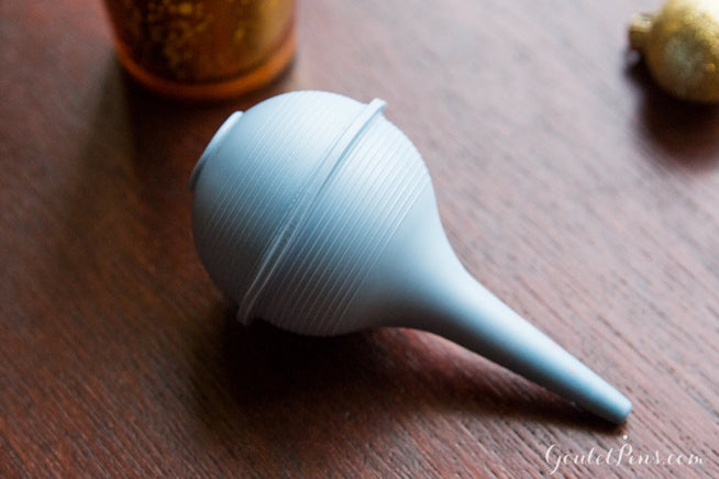 Bulb syringe on wooden desk