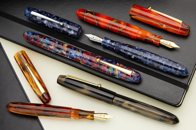Edison Collier Fountain Pens laying on an open notebook