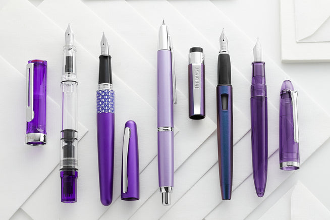 TWSBI ECO in Transparent Purple, Pilot Metropolitan in Violet Leopard, Pilot Décimo in Purple, Diplomat Magnum in Prismatic Purple, and Sailor 1911 Fountain Pens
