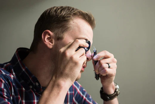 Man looking through magnifying glass