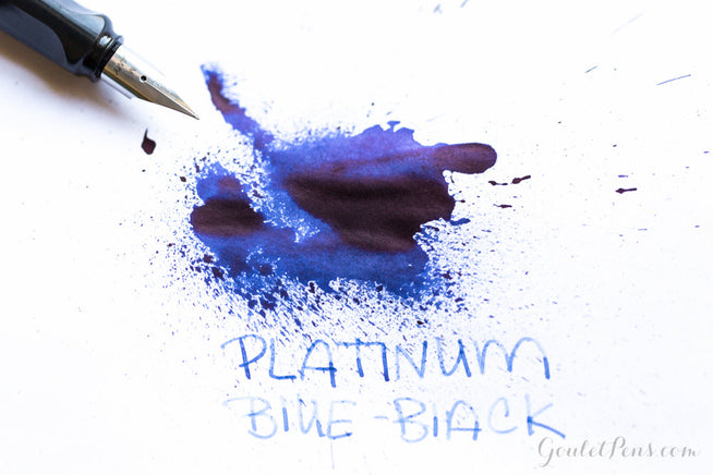 Platinum Blue Black ink splatter with handwriting and a LAMY fountain pen uncapped