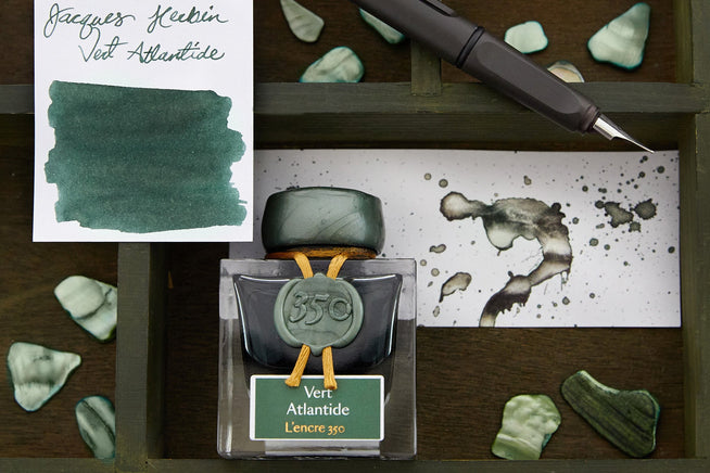 Jacques Herbin 350 Vert Atlantide Swab, splatter and bottle on a desk