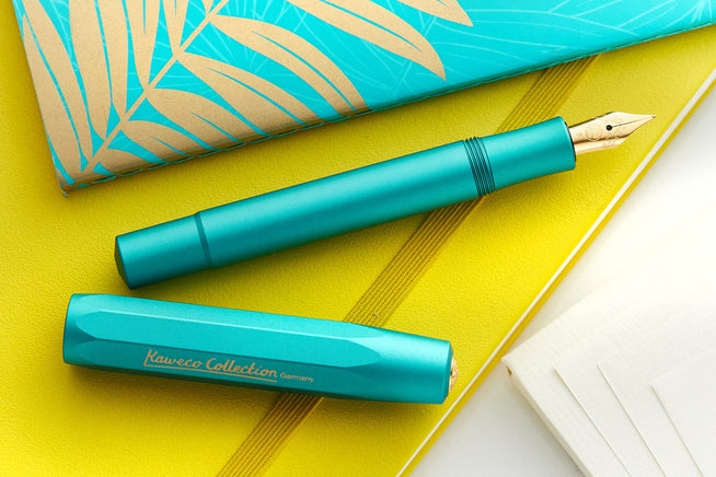 Teal Kaweco Al-sport uncapped on yellow journal 