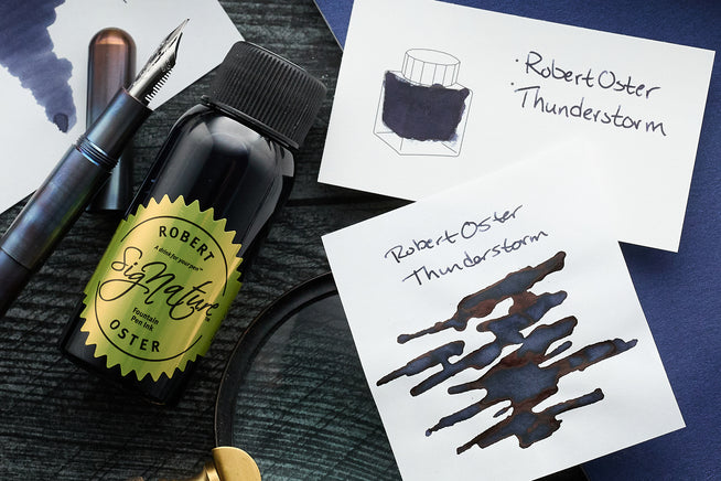 Robert Oster Thunderstorm Fountain Pen Ink, ink swabs, brown desk, fountain pens