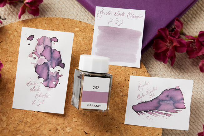 Sailor Ink Studio 252 writing splatter, swab and bottle on cork background