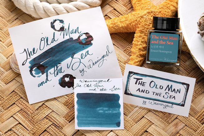 Wearingeul The Old Man and the Sea fountain pen ink swab, writing sample, and swatch on rattan background