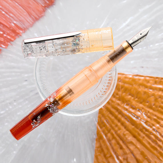 Fountain pen with decorative elements on a textured surface