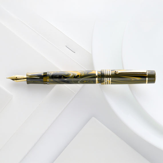 Delta Neo Gallery Fountain Pen in Marigold, a vibrant green and yellow resin pen with gold trim and nib.