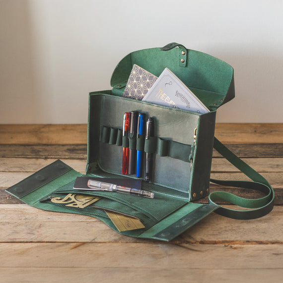 Stylish writing bag with compartments for notebooks, pens, and accessories. Made of distressed Crazy Horse Forest Green leather.