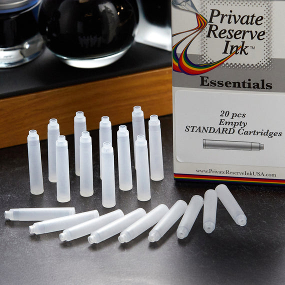 Set of empty ink cartridges with a box labeled 'Private Reserve Ink Essentials' on a dark surface.