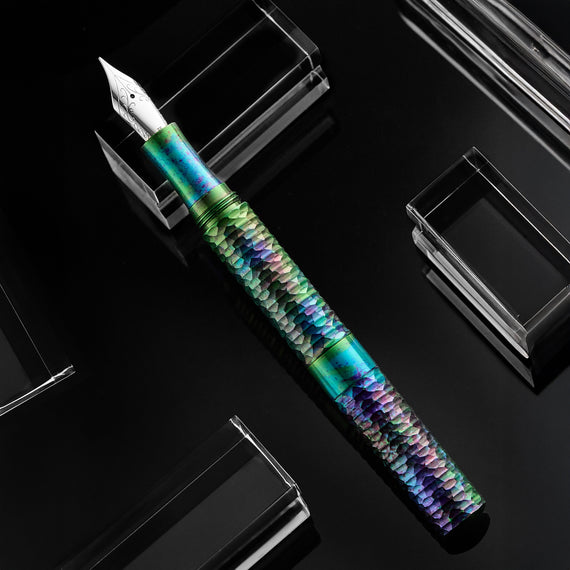 Multicolored fountain pen on a black reflective surface