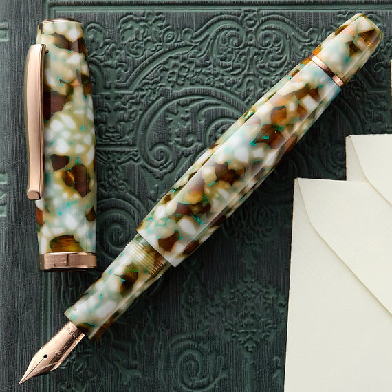 Fountain pen with marbled design on a textured surface