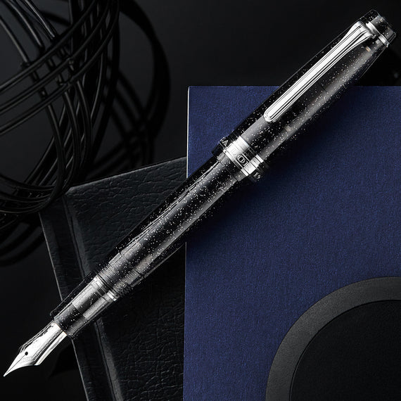 Fountain pen with sparkles on a dark background