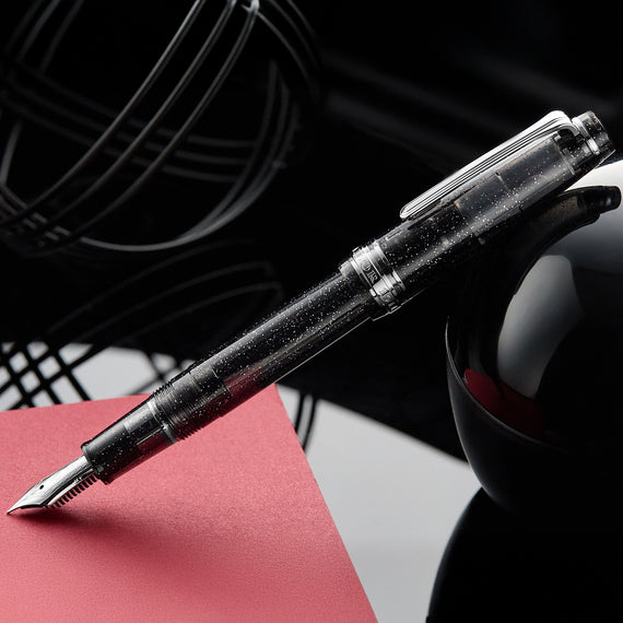 Fountain pen on a red surface with a blurred background