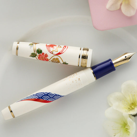 Fountain pen with floral design on a light background
