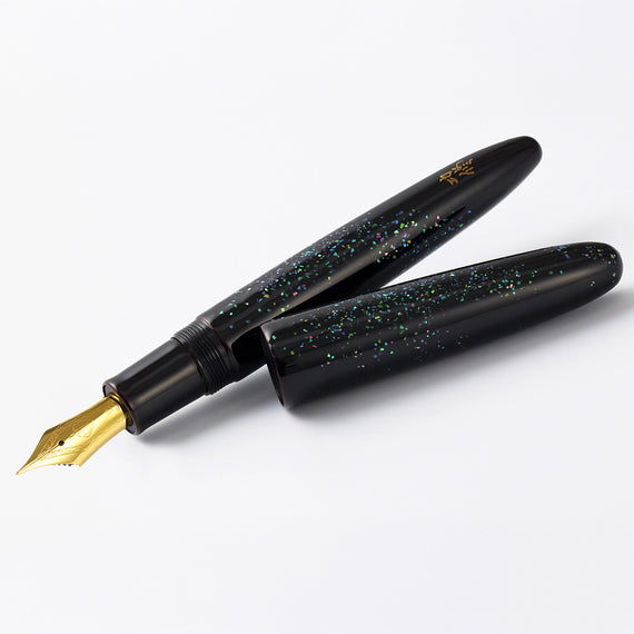 Black glittery fountain pen with gold accents on a white background