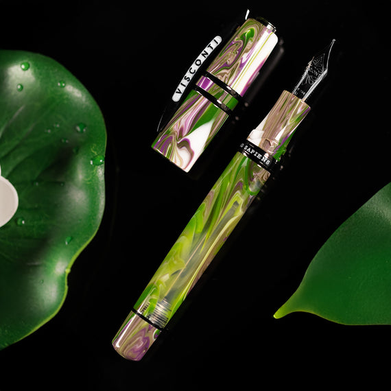 Fountain pen with green and purple design on a black background
