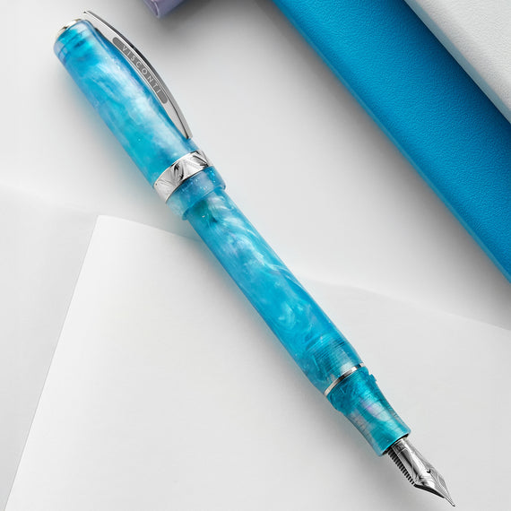 Blue marbled pen with silver accents on a white background