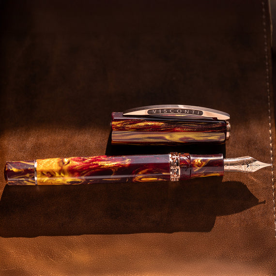 Visconti fountain pen on a brown leather surface