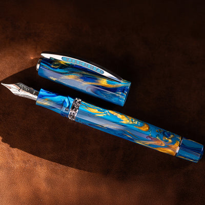Blue and gold marbled fountain pen on a brown surface